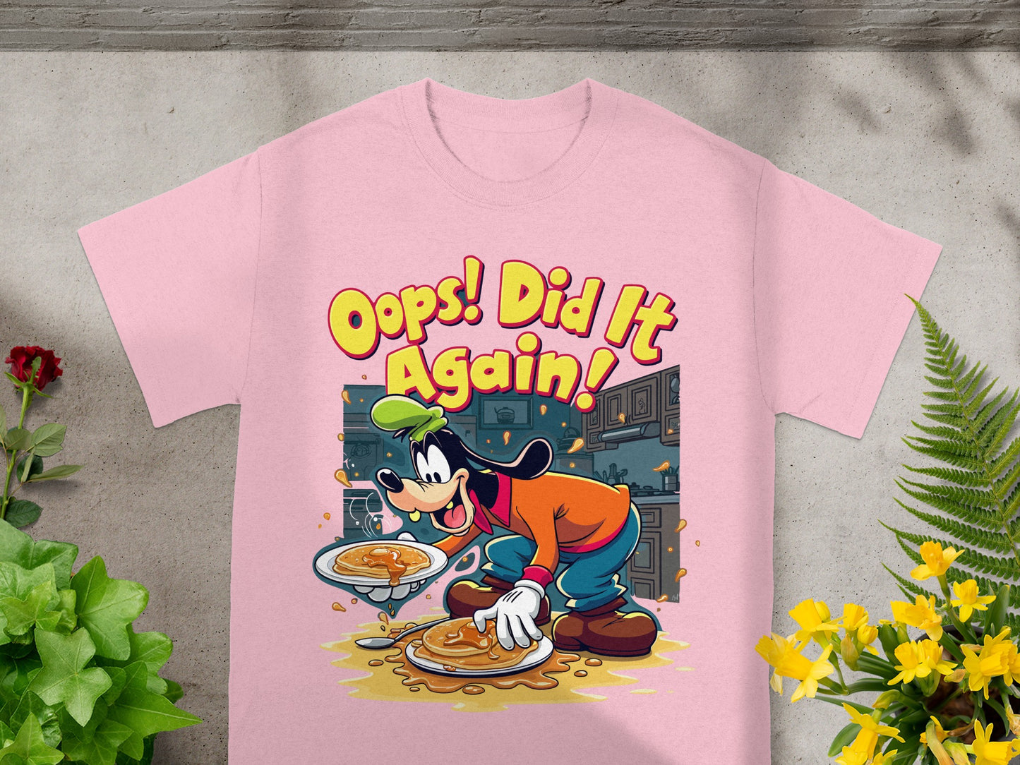 Pink t-shirt with Goofy character spilling pancakes, with text "Oops! Did It Again!".