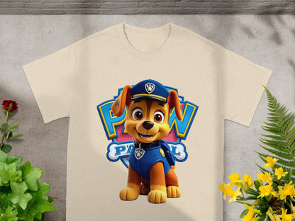 Chase from Paw Patrol sitting in front of a Paw Patrol logo on a cream t-shirt.