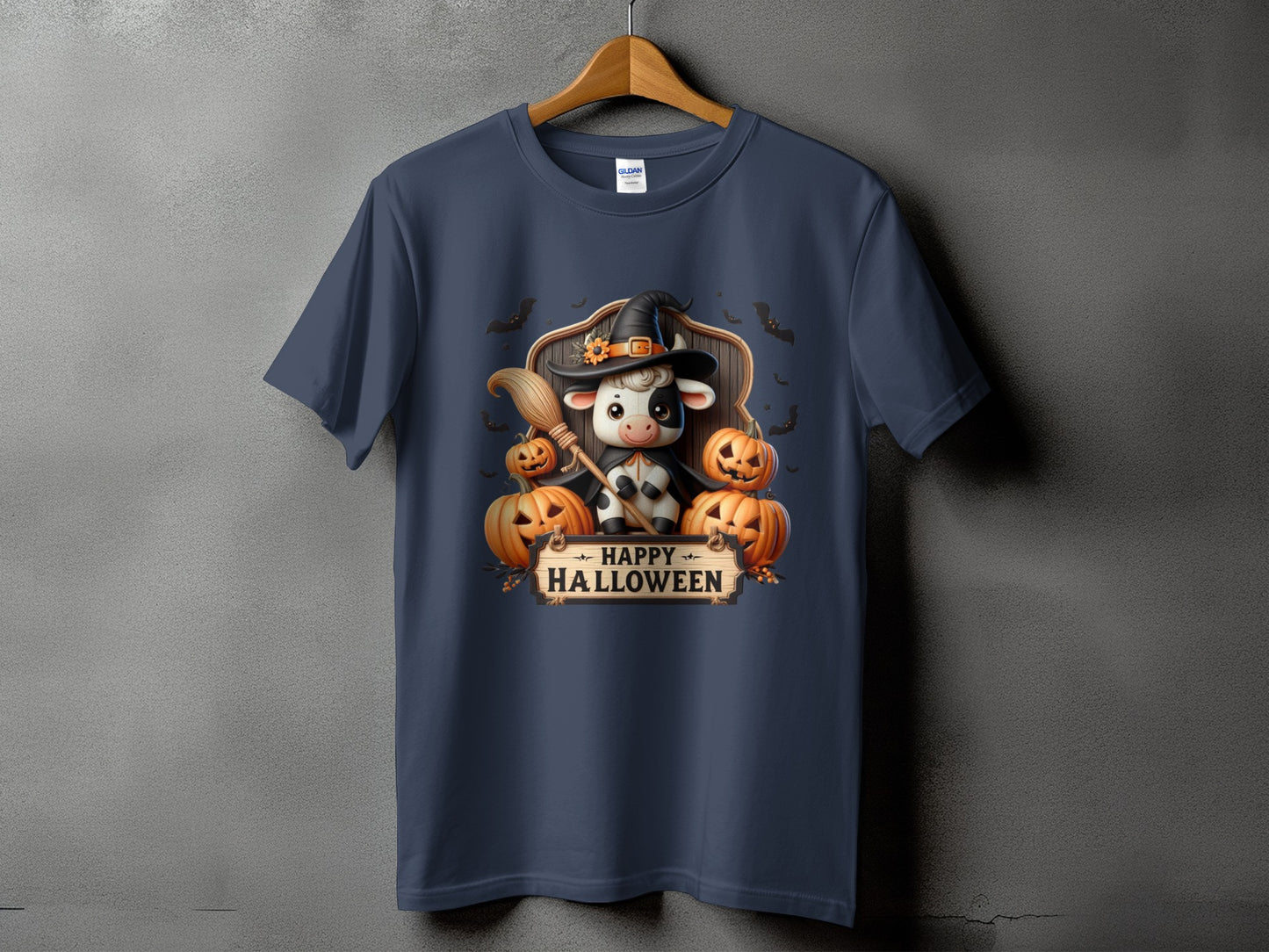 Dark blue t-shirt with a Halloween graphic featuring a cow in a witch hat, pumpkins, and bats.