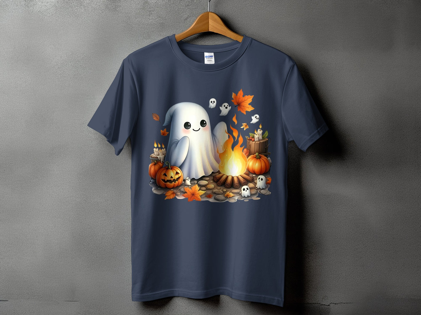 Cute ghost with pumpkins and leaves around a campfire on a t-shirt.