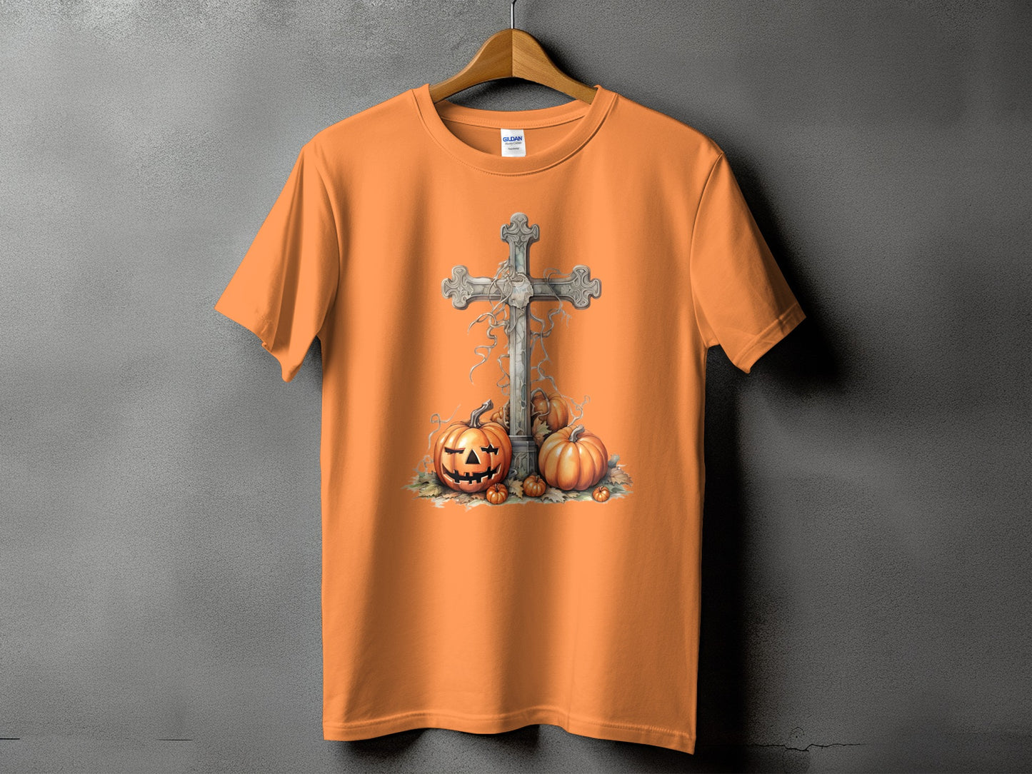 Orange t-shirt with carved pumpkins and a cross design.
