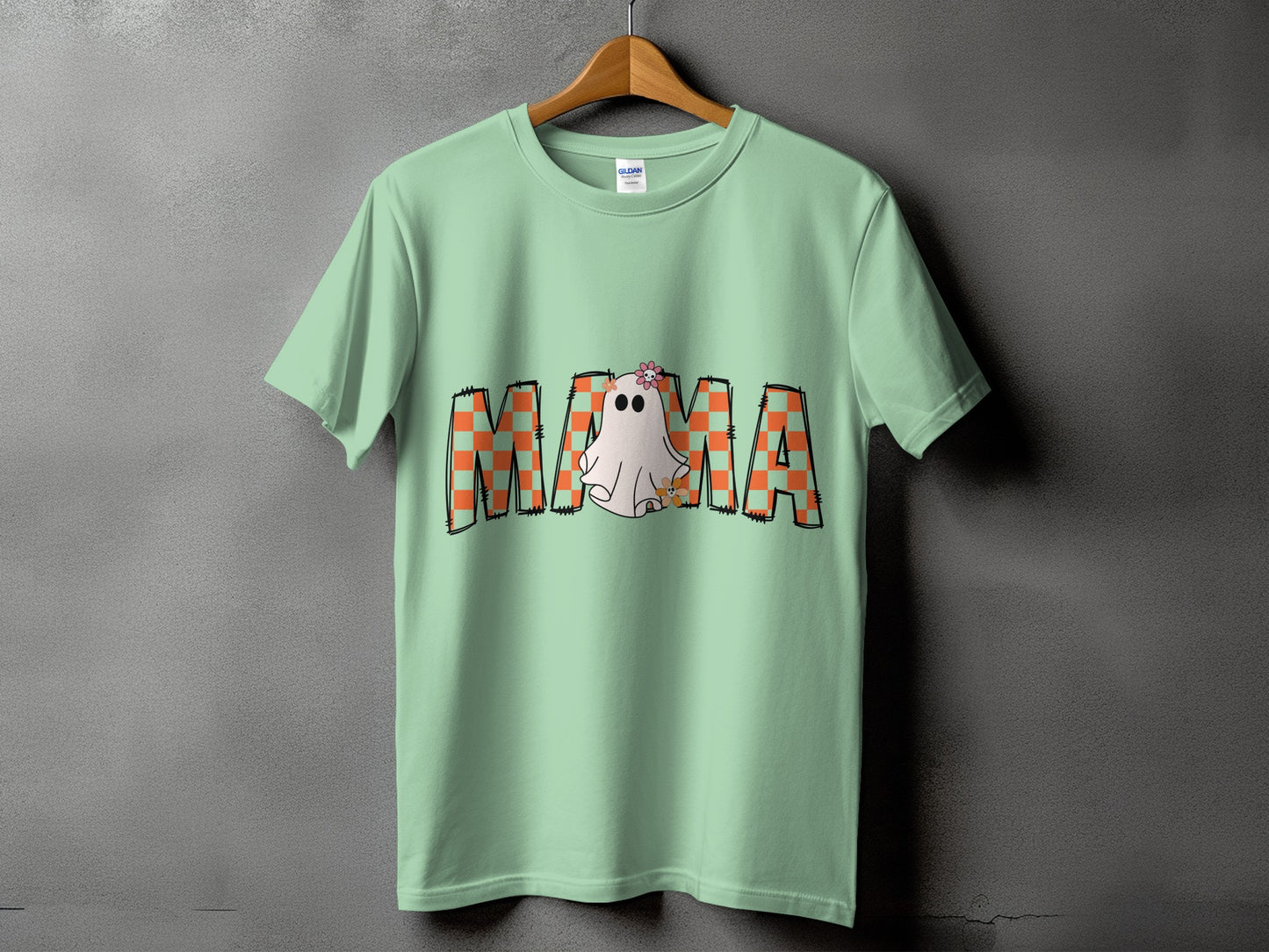 Mint green t-shirt with "Mama" text featuring a ghost and checkerboard pattern.