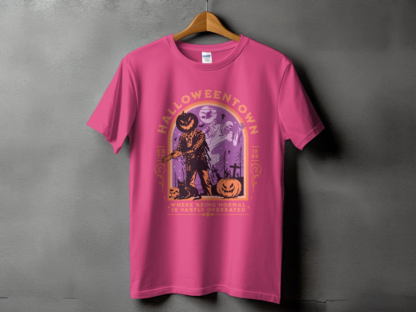 Pink t-shirt with "Halloweentown" graphic featuring a scarecrow and ghosts.