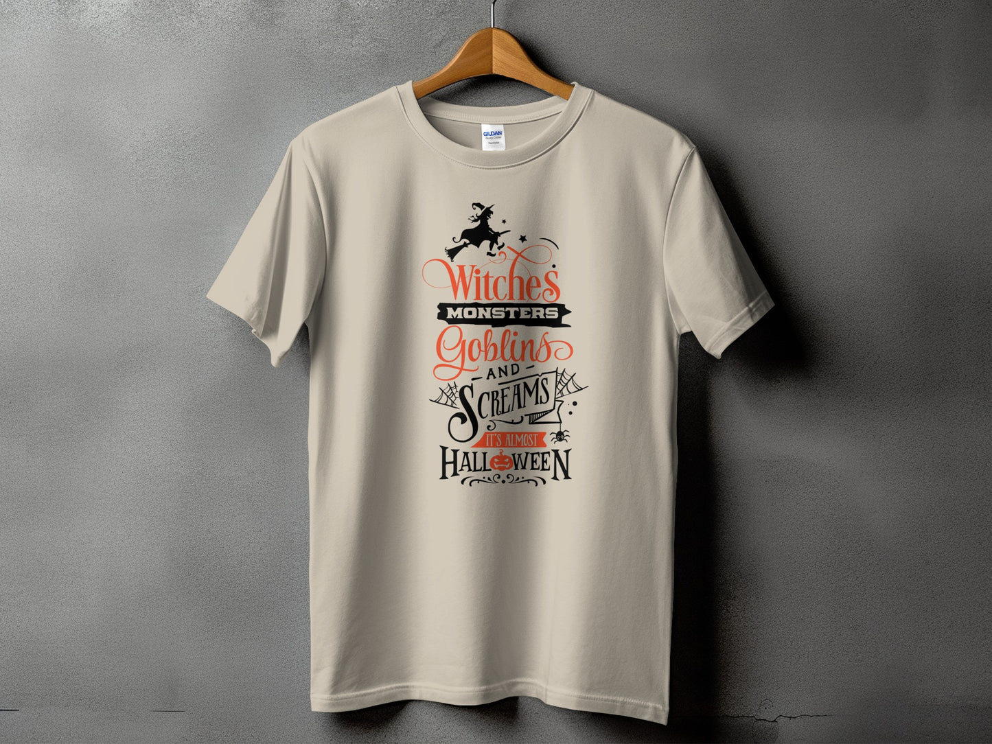 Light beige t-shirt with Halloween design featuring witches, monsters, goblins, screams, and "It's Almost Halloween."