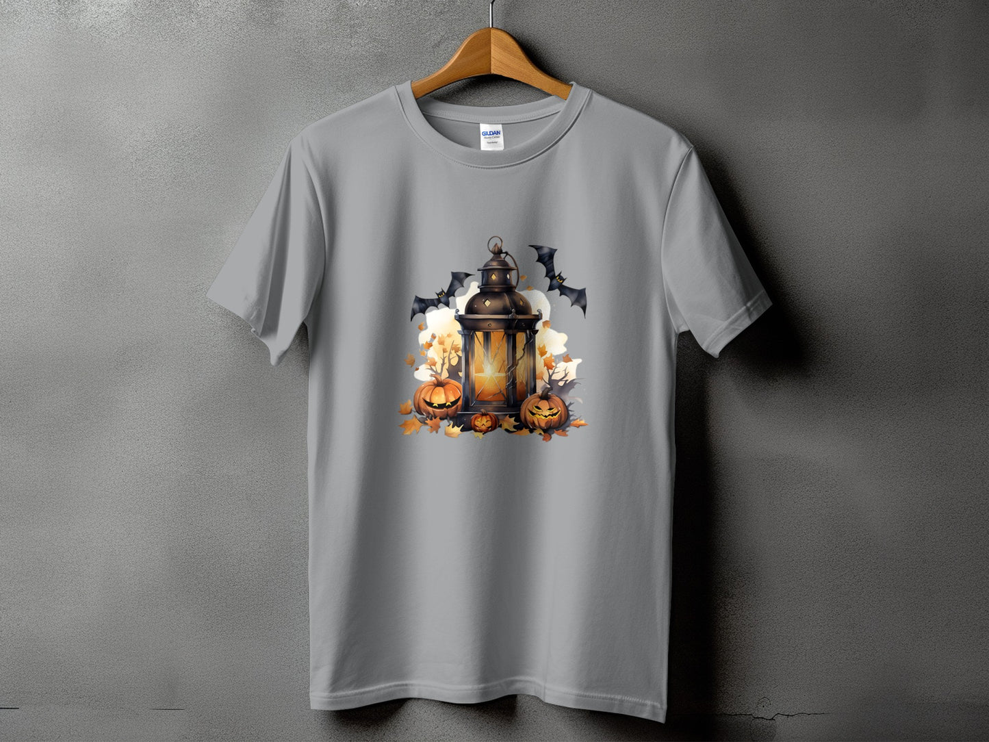 Gray t-shirt with a Halloween design of a lantern, pumpkins, and bats.