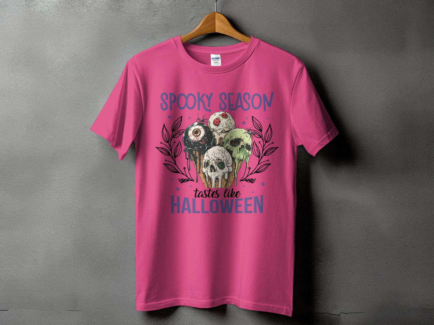 Pink t-shirt with "Spooky Season Tastes Like Halloween" text and eerie ice cream cones.