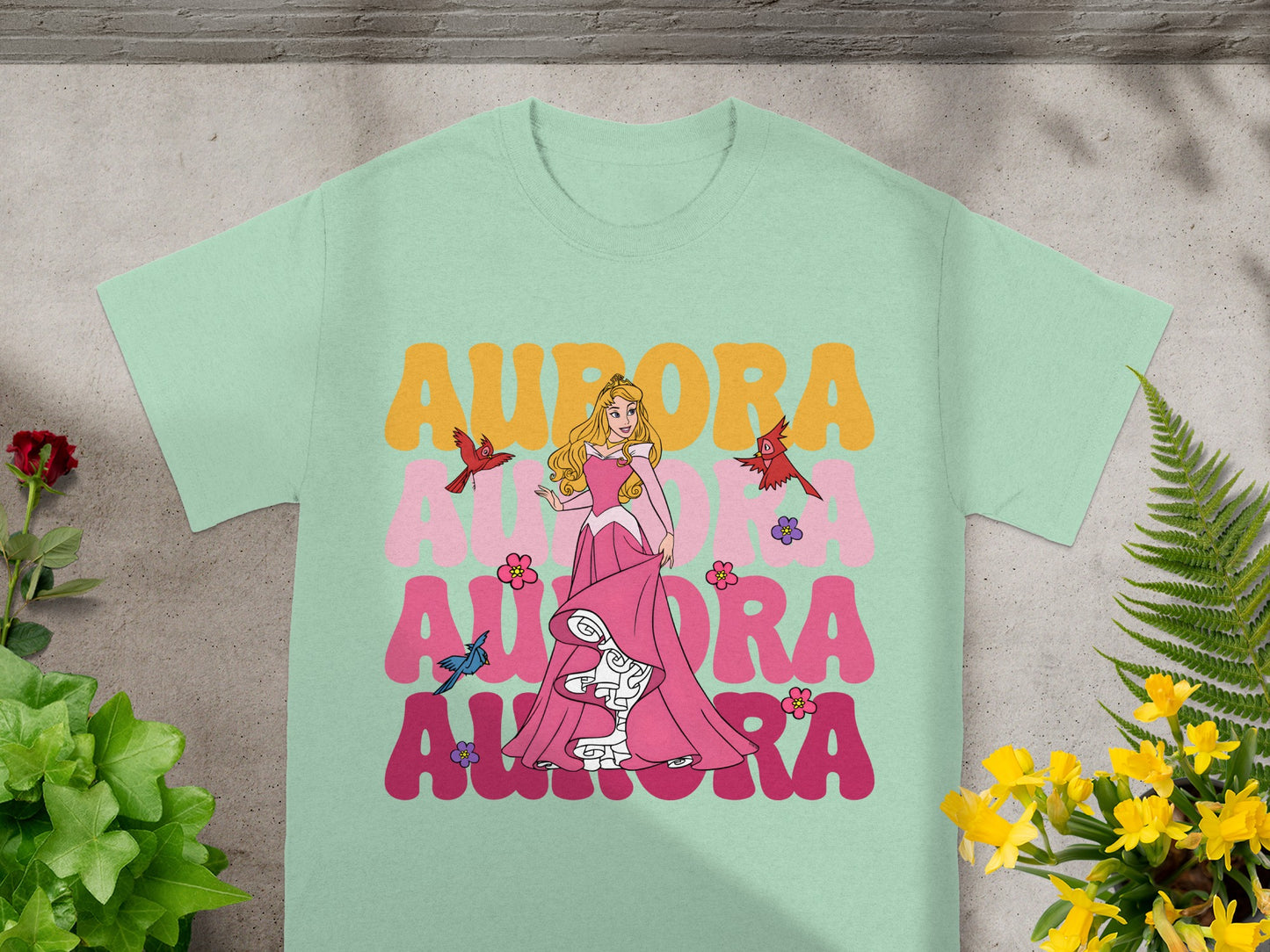 Mint green t-shirt with Aurora and birds graphic design.