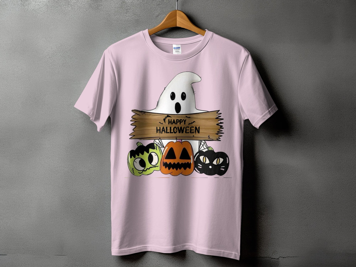 Pink t-shirt with a Halloween graphic of a ghost, pumpkins, and text that says "HAPPY HALLOWEEN".