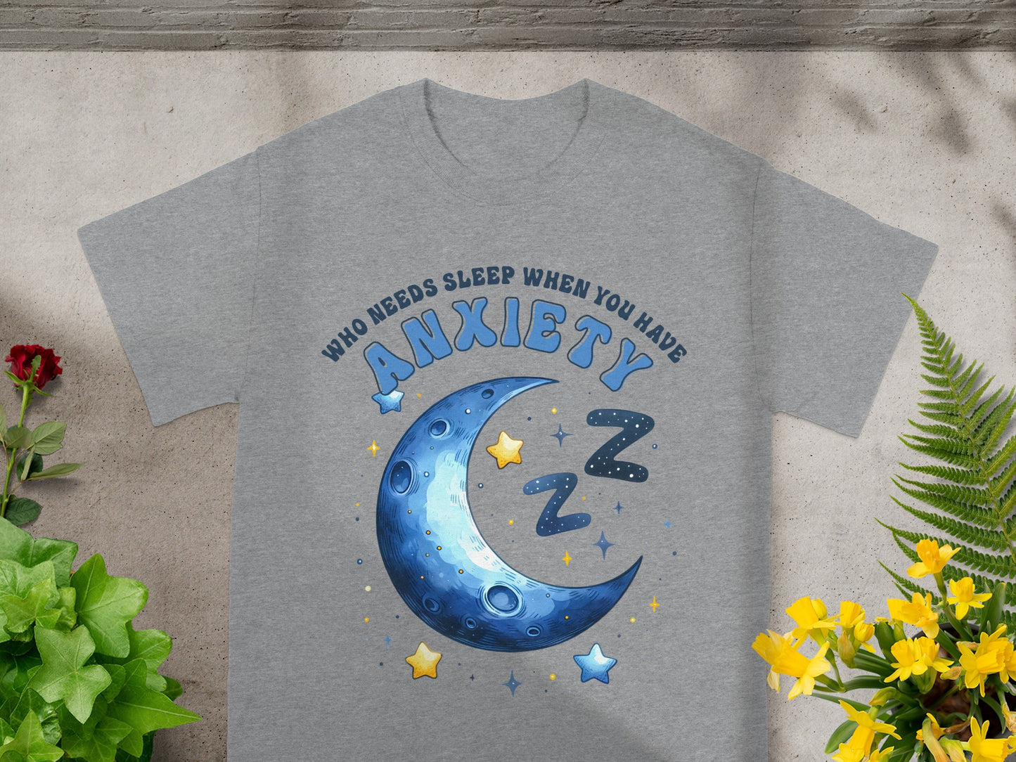 Gray t-shirt with a crescent moon, stars, and text "ANXIETY" and "WHO NEEDS SLEEP WHEN YOU HAVE".