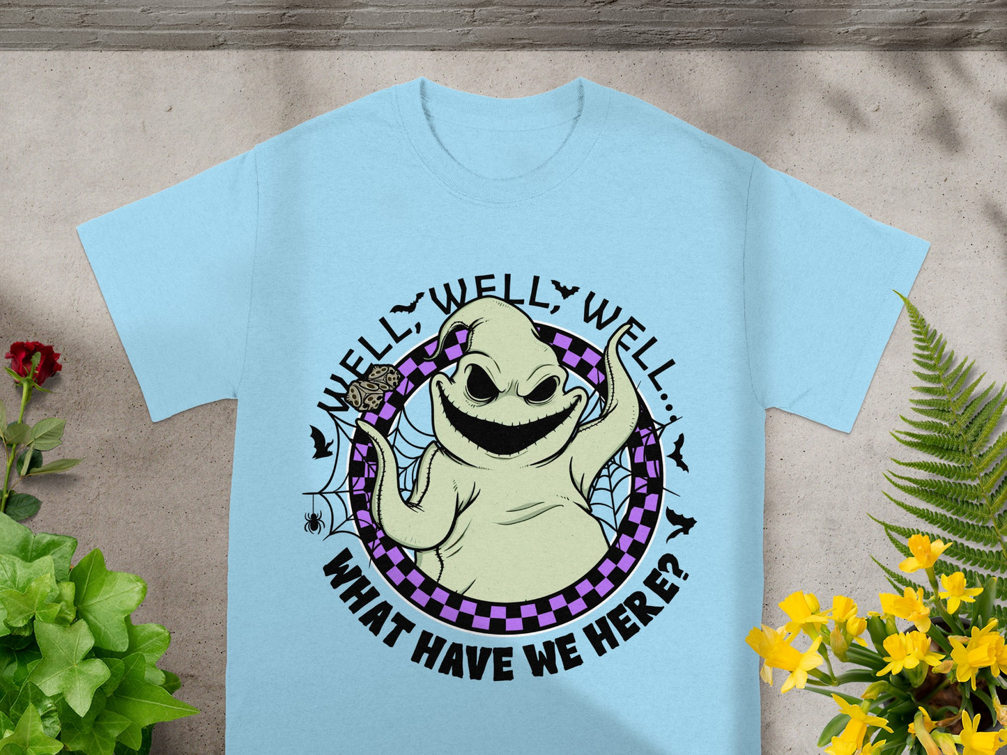 Light blue t-shirt with Oogie Boogie character and text "WELL, WELL, WELL... WHAT HAVE WE HERE?"
