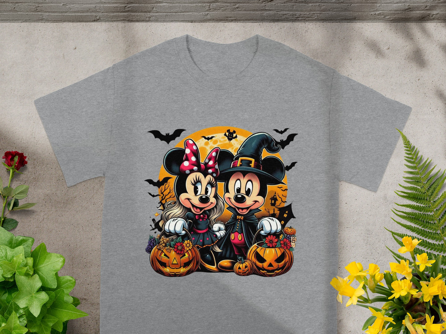 Mickey and Minnie Mouse in Halloween costumes holding jack-o'-lanterns.