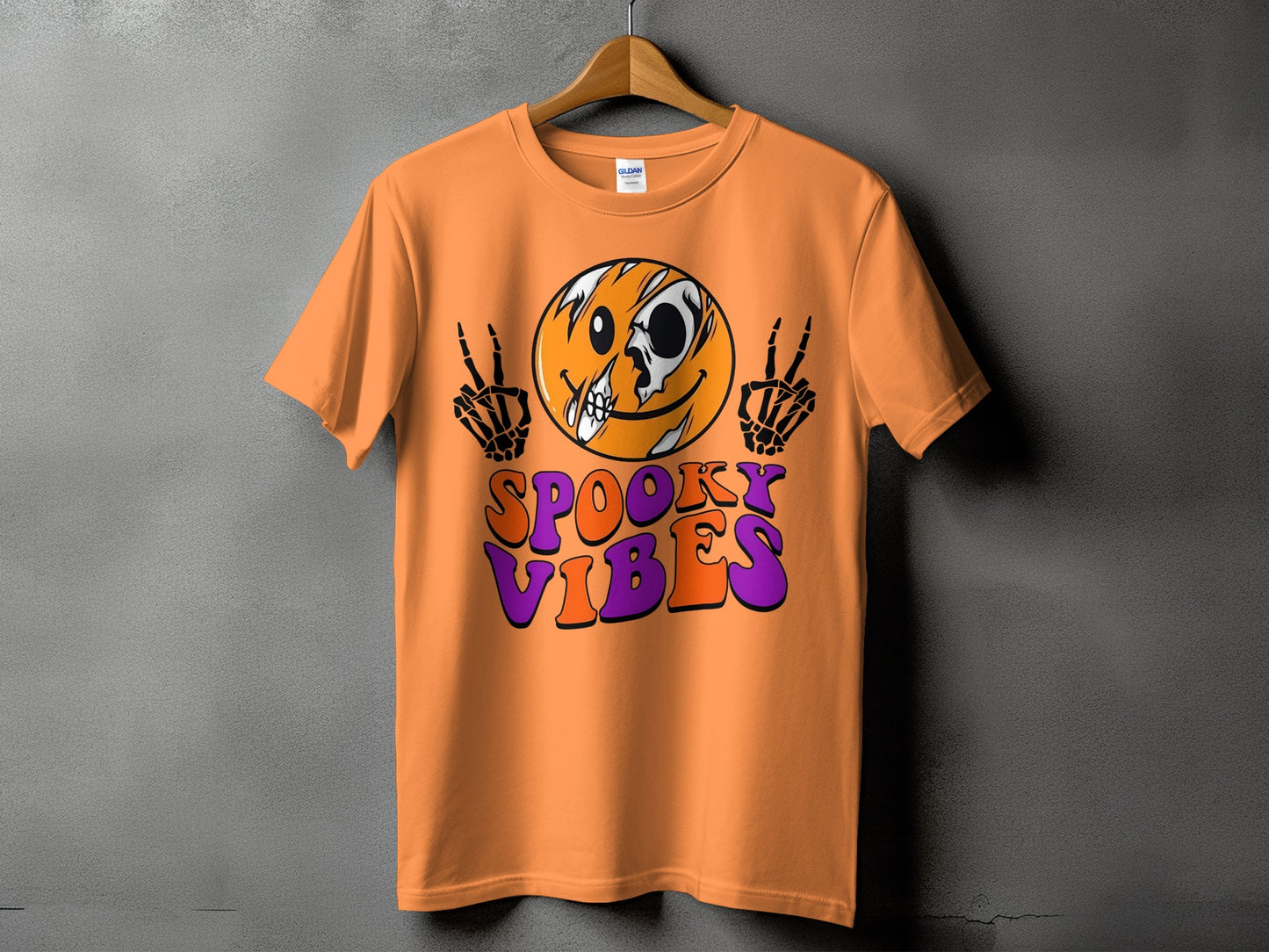 Orange t-shirt with a skull-faced emoji and "Spooky Vibes" text.