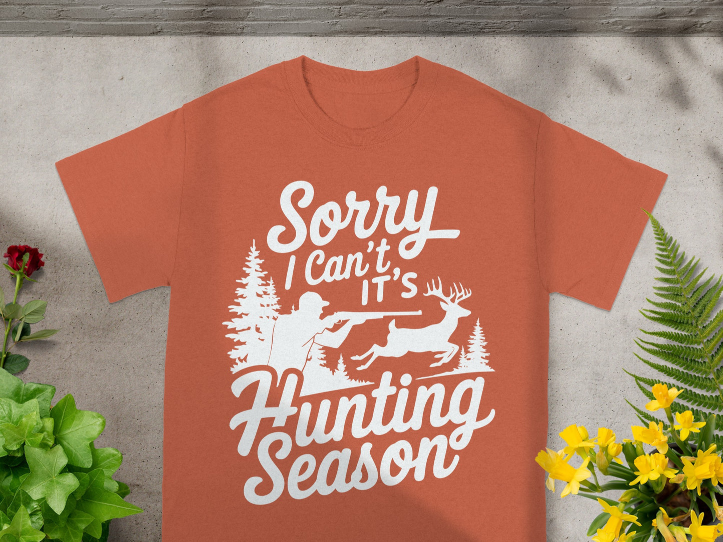 T-shirt with white text reading "Sorry I Can't It's Hunting Season" and hunting graphic.