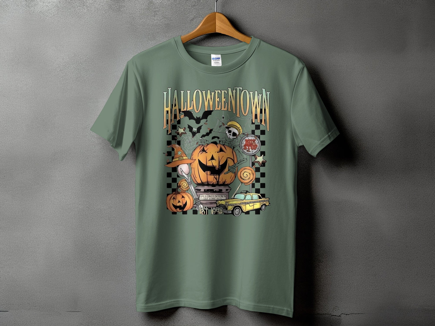 Green t-shirt with Halloweentown graphic featuring pumpkins, bats, and a yellow taxi.