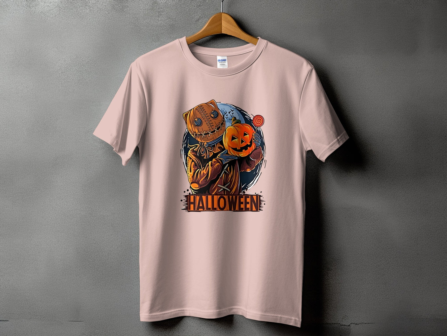 T-shirt with Halloween graphic of a scarecrow holding a pumpkin and lollipop.