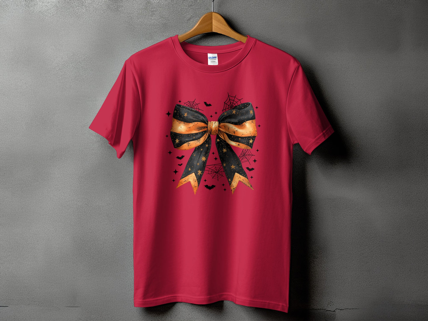 Red t-shirt with a Halloween bow graphic featuring bats and spiderwebs.