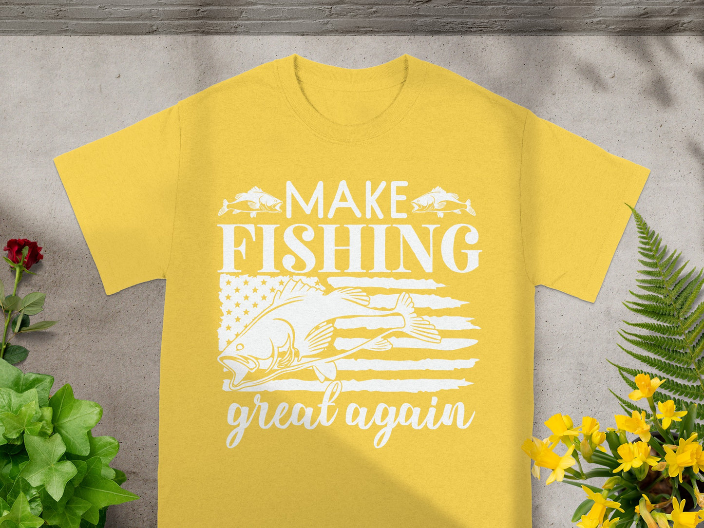 Yellow t-shirt with white text and graphic: "MAKE FISHING great again," featuring fish and an American flag.