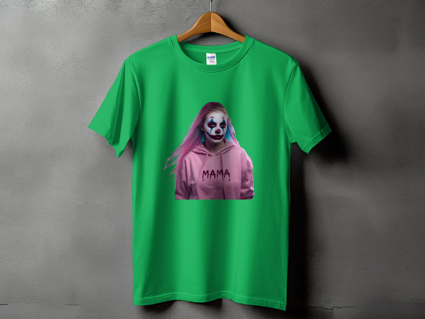 Green t-shirt with a person in a pink hoodie and clown makeup, text "MAMA"