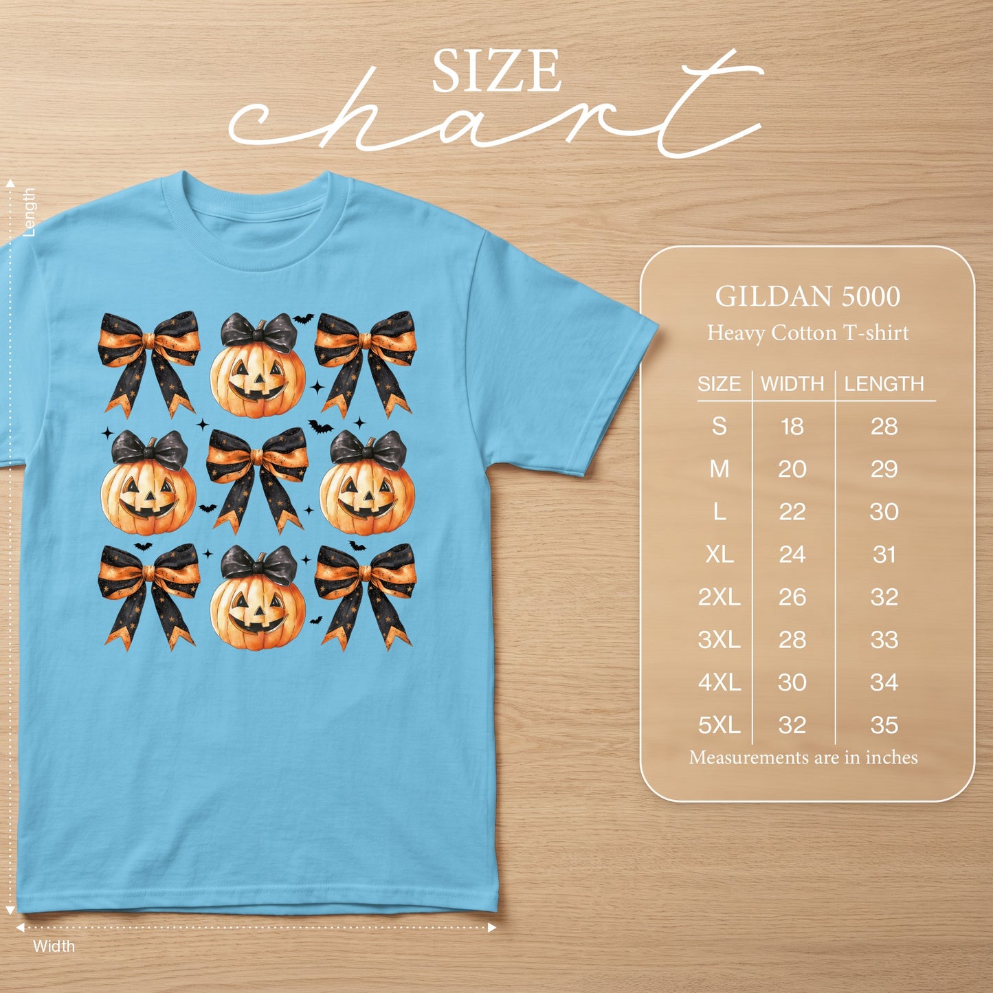 Light blue t-shirt with watercolor pumpkins, bows, and bats design and size chart.