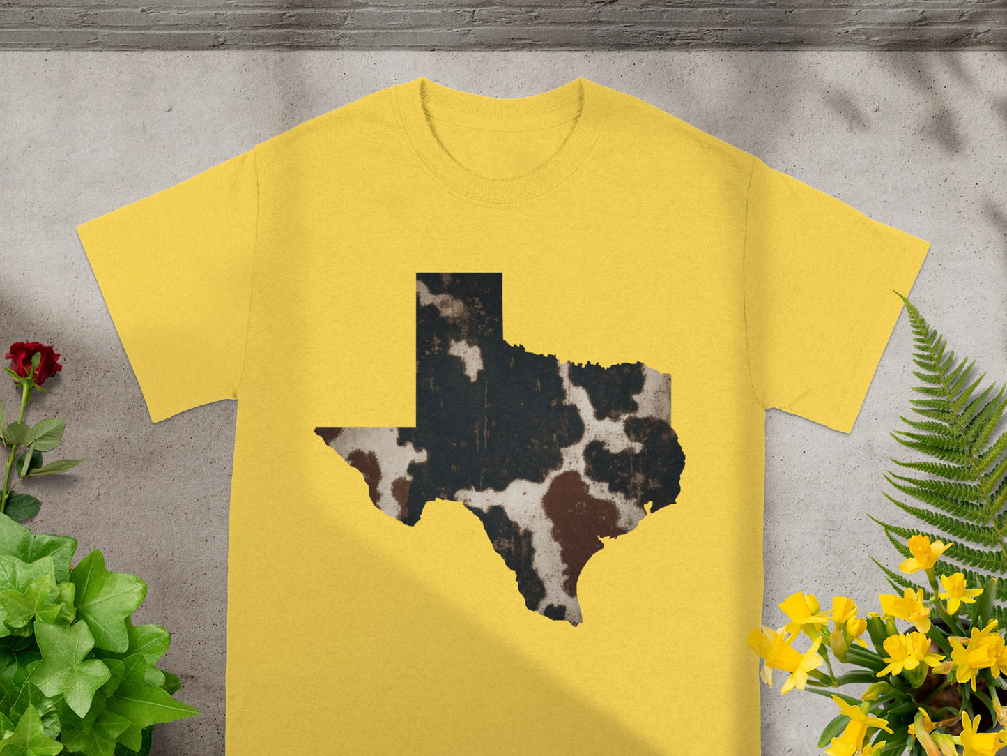Yellow t-shirt with a Texas outline graphic featuring cowhide texture.