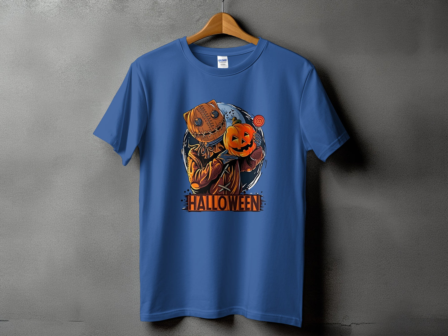 Blue t-shirt with burlap sack doll holding a pumpkin and a lollipop.