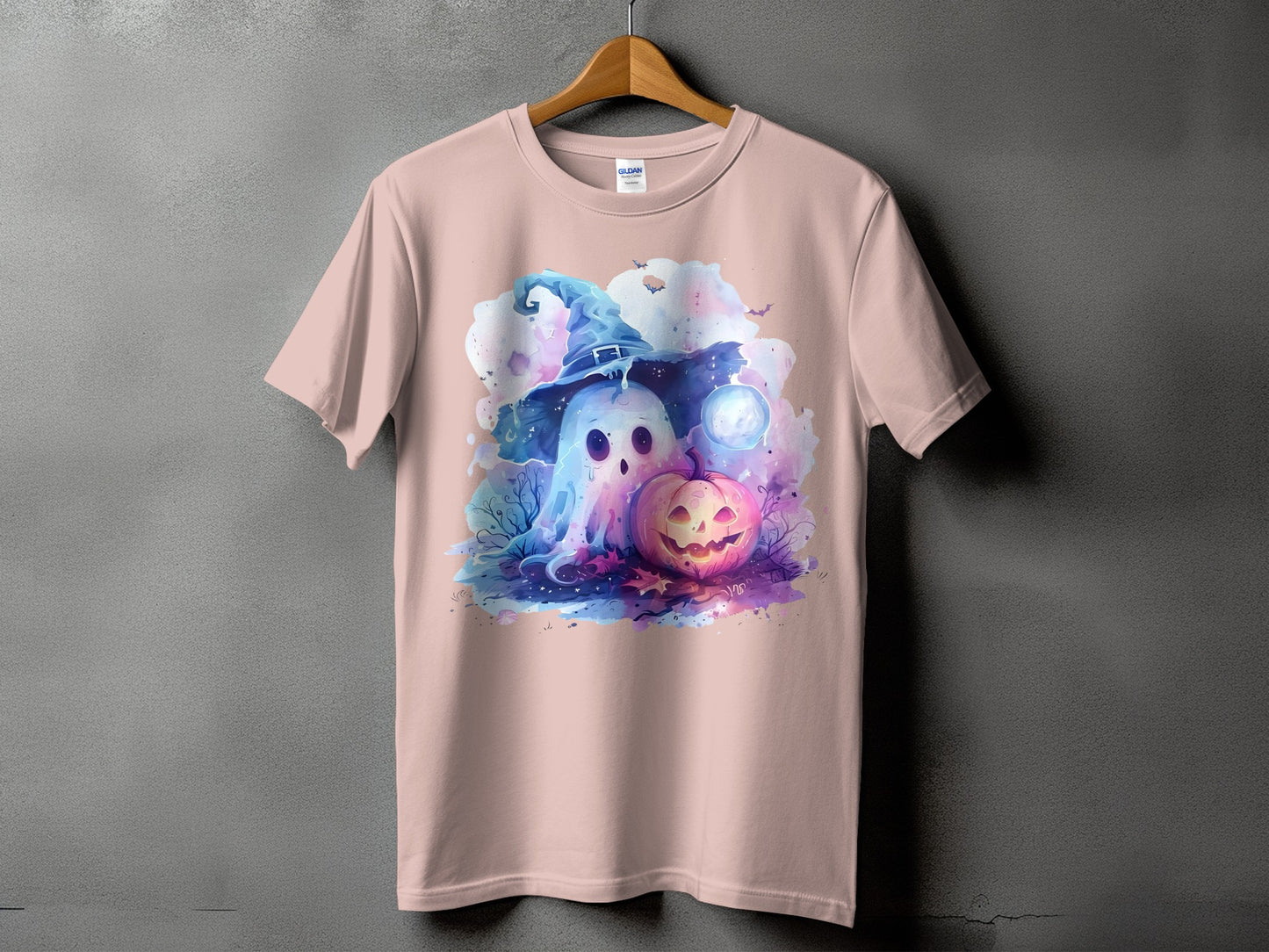 Ghost in witch hat with pumpkin and moon on pink t-shirt.