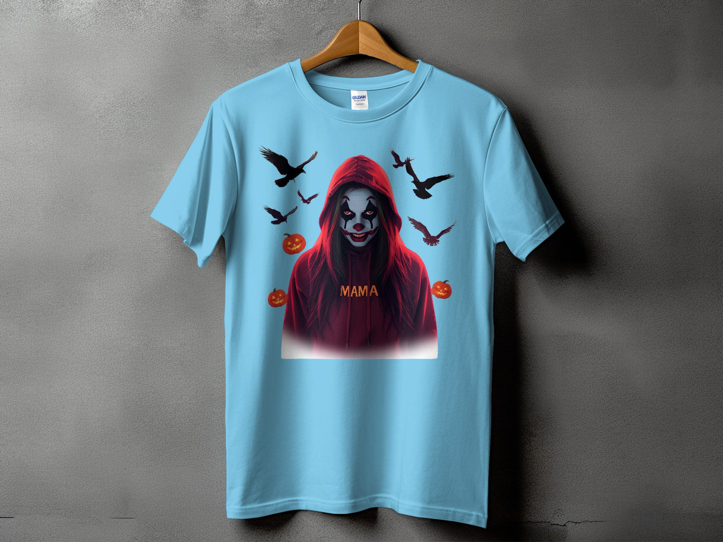 Light blue t-shirt with a creepy clown graphic, pumpkins, and flying birds.