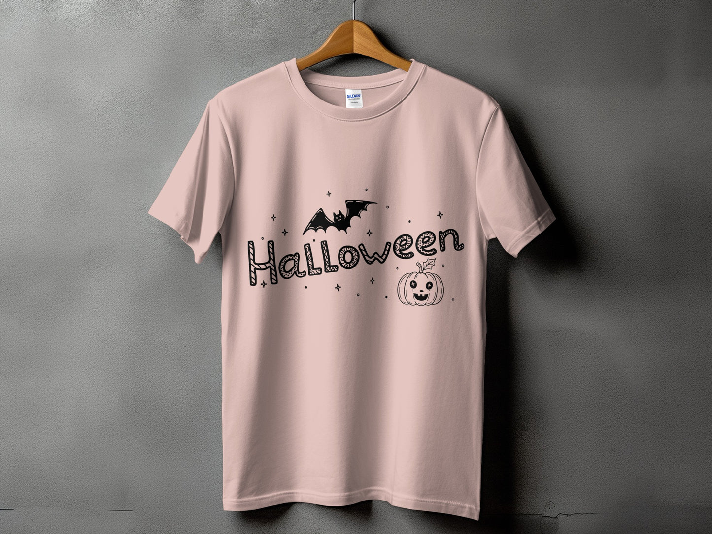 Pink t-shirt with "Halloween" text, bat, and jack-o'-lantern graphic.