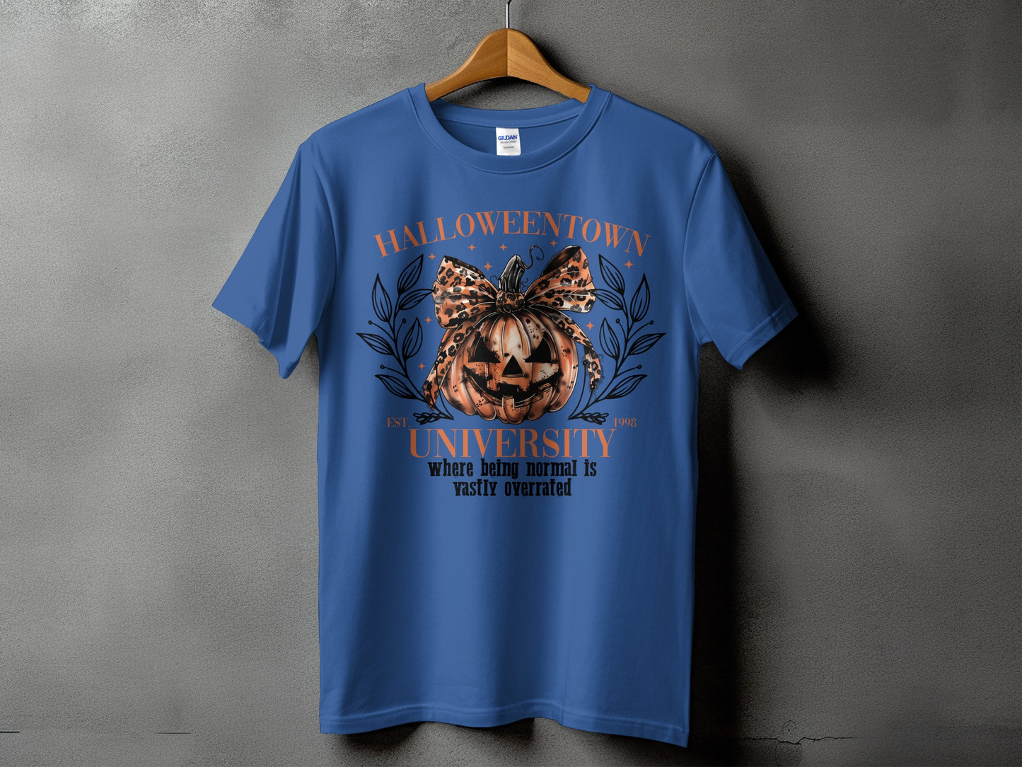 Blue t-shirt with Halloween town university graphic featuring a pumpkin and text.