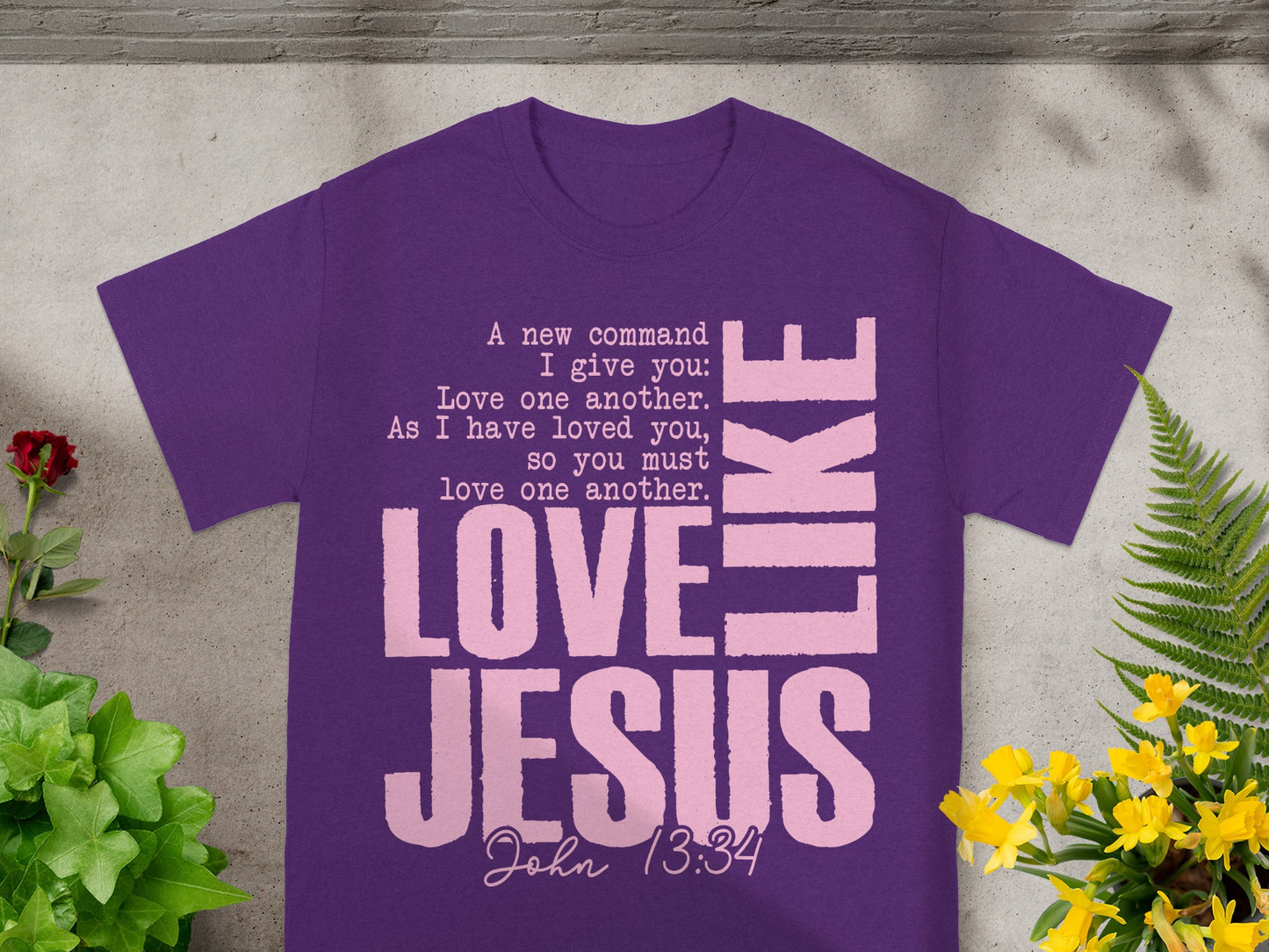 Purple t-shirt with "LOVE JESUS" and John 13:34 in pink lettering.