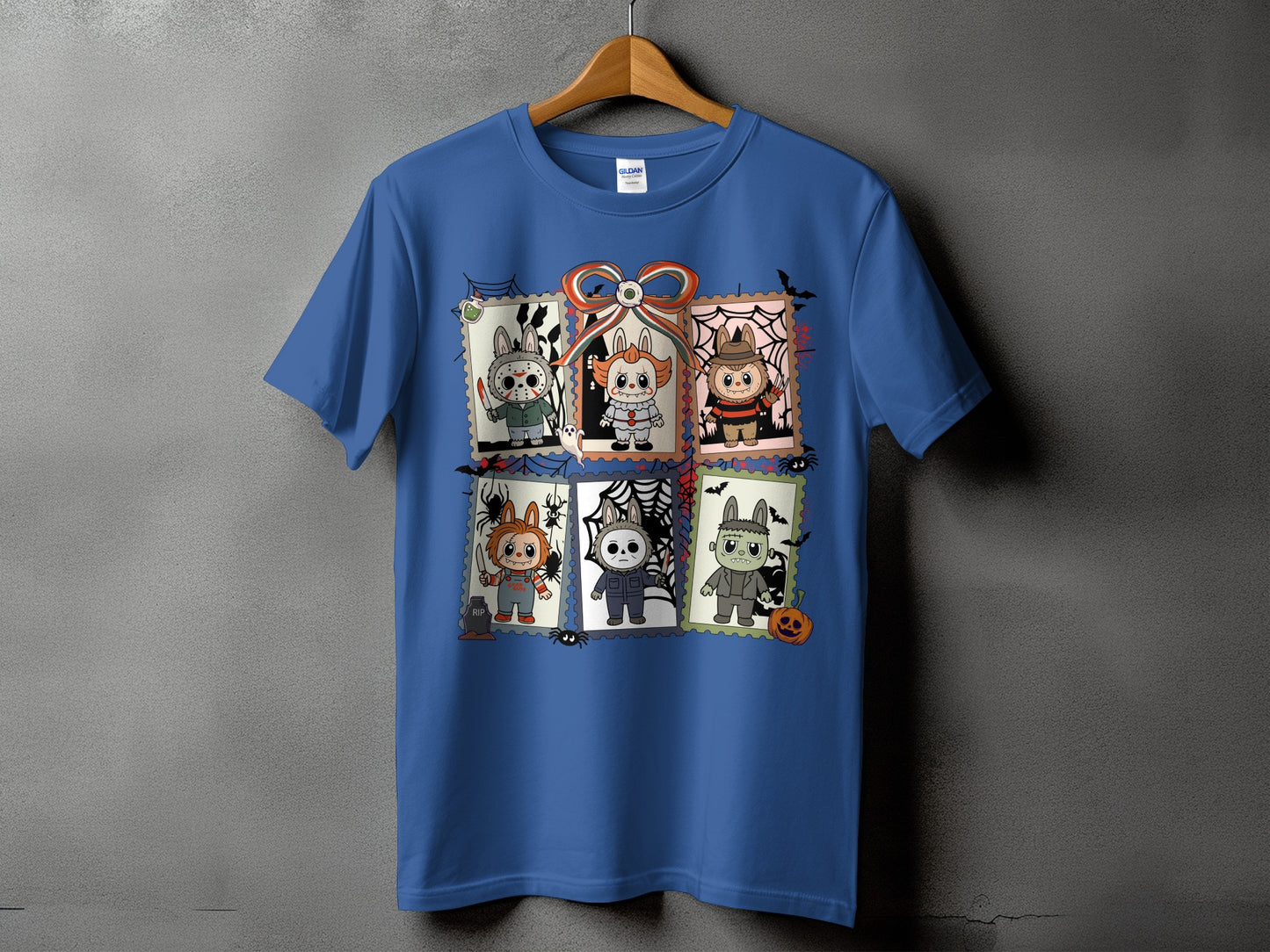 Blue t-shirt with six postage stamps featuring horror characters in a cute style.
