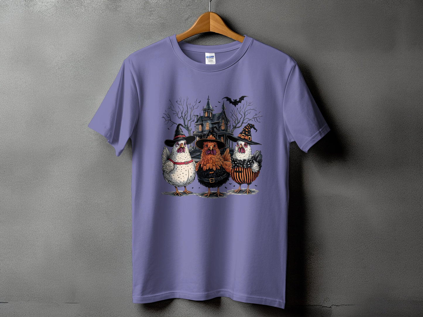 T-shirt with three chickens in Halloween costumes in front of a haunted house.