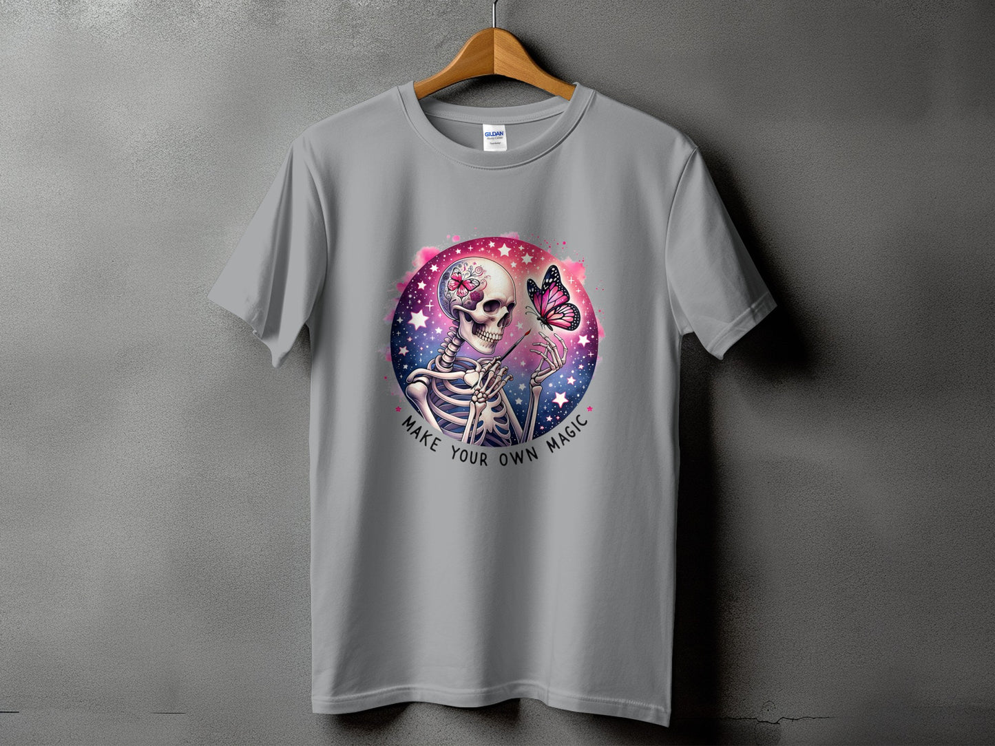 Grey t-shirt with skeleton and butterfly graphic, "Make Your Own Magic" text.
