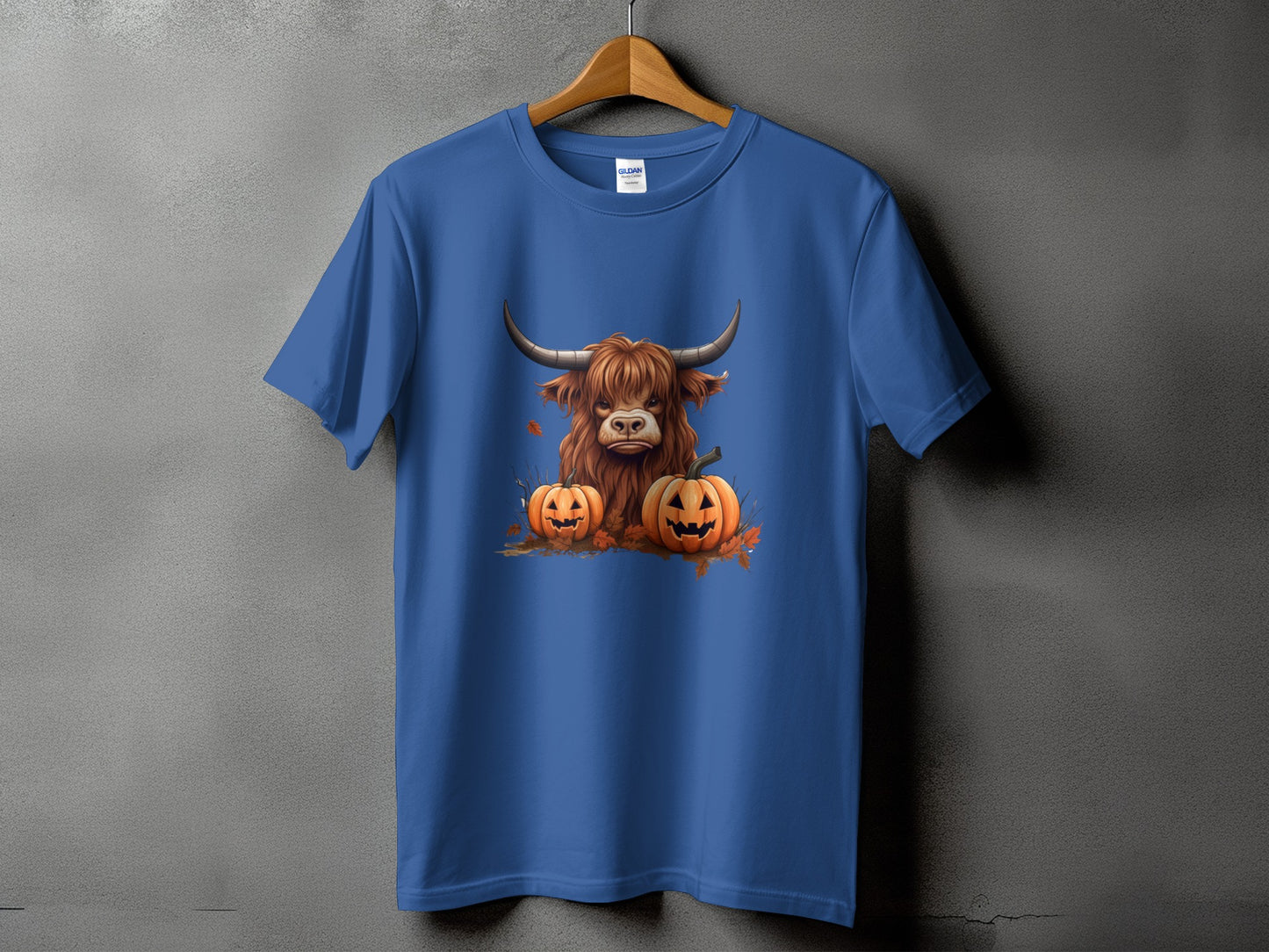 Blue t-shirt with a Highland cow and pumpkins graphic.