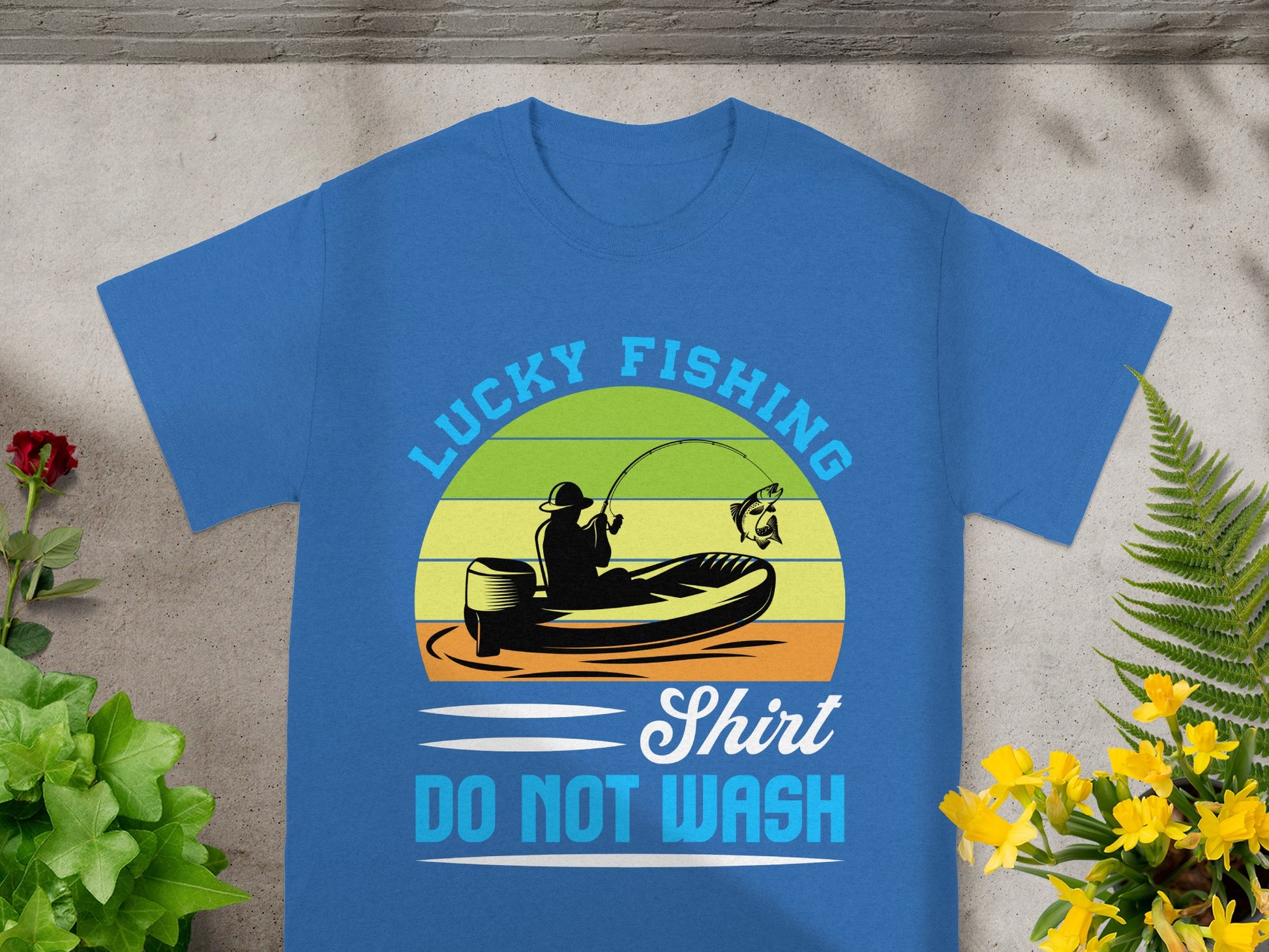 Blue t-shirt with "Lucky Fishing" graphic of a person fishing from a boat, and "DO NOT WASH" text.