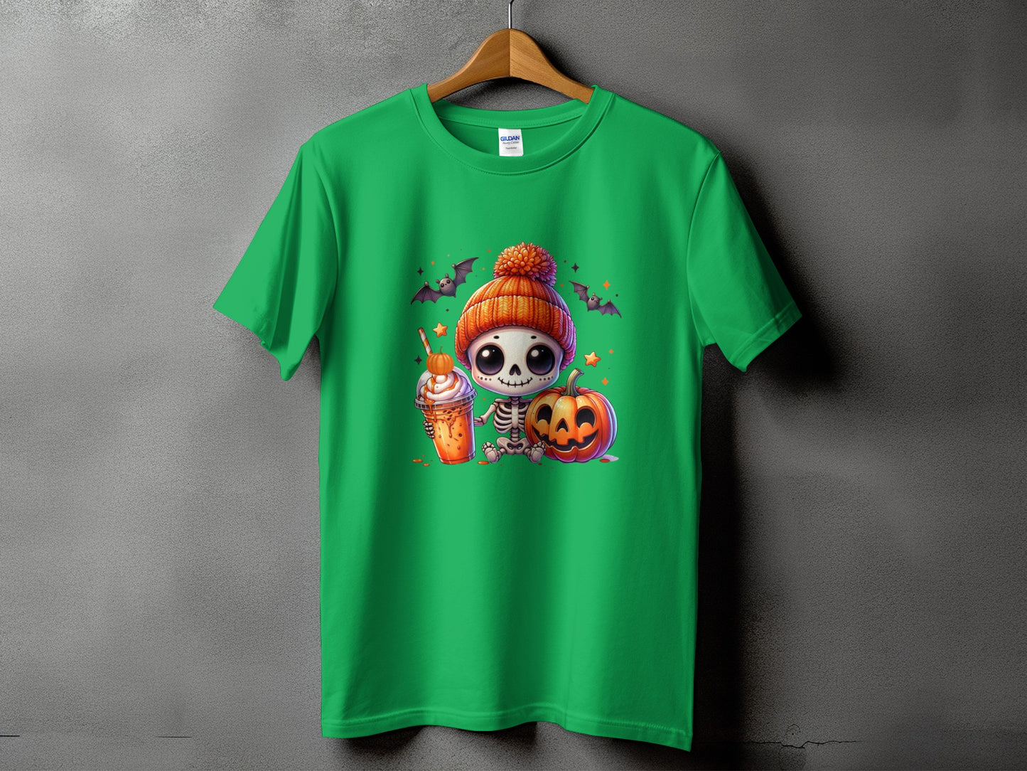 Green t-shirt with a cute skeleton, pumpkin, and Halloween drink graphic.