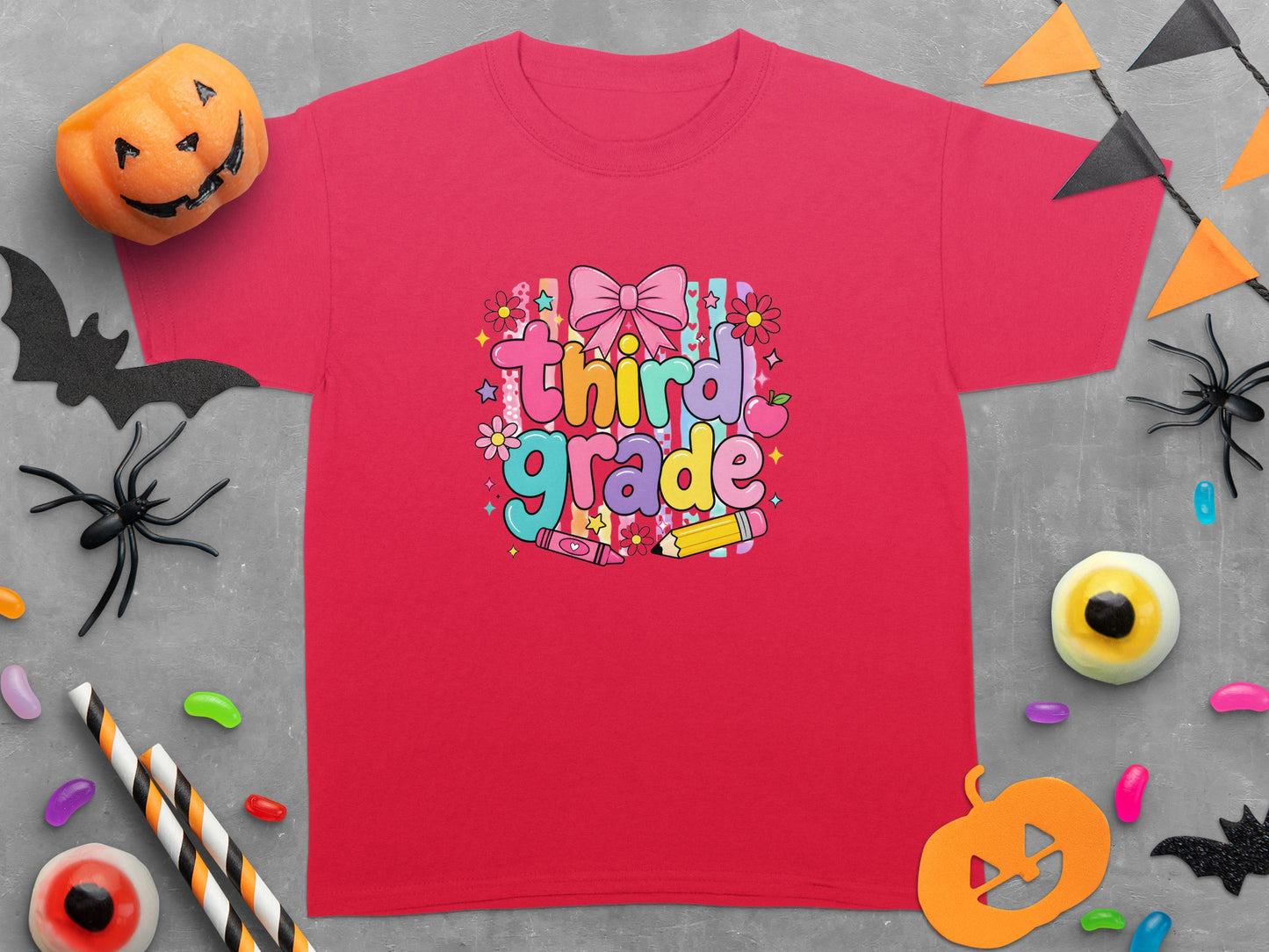 Red t-shirt with "Third Grade" text, a bow, flowers, and school supplies.