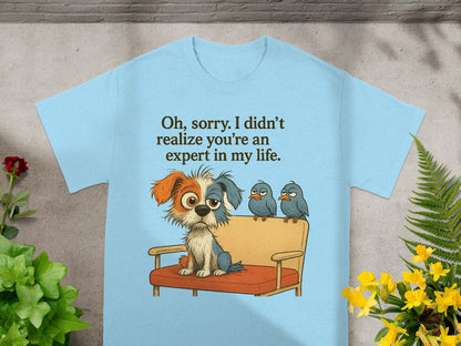 Light blue t-shirt with a cartoon dog and three birds on a couch with text.