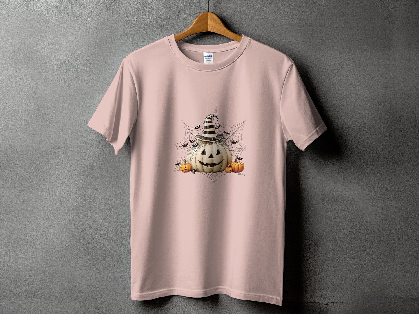Pink t-shirt with Halloween pumpkin design and bats on a spiderweb.