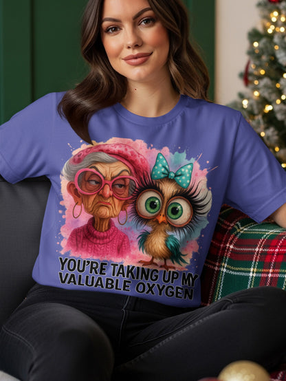 Woman wearing a purple t-shirt with an owl and text.