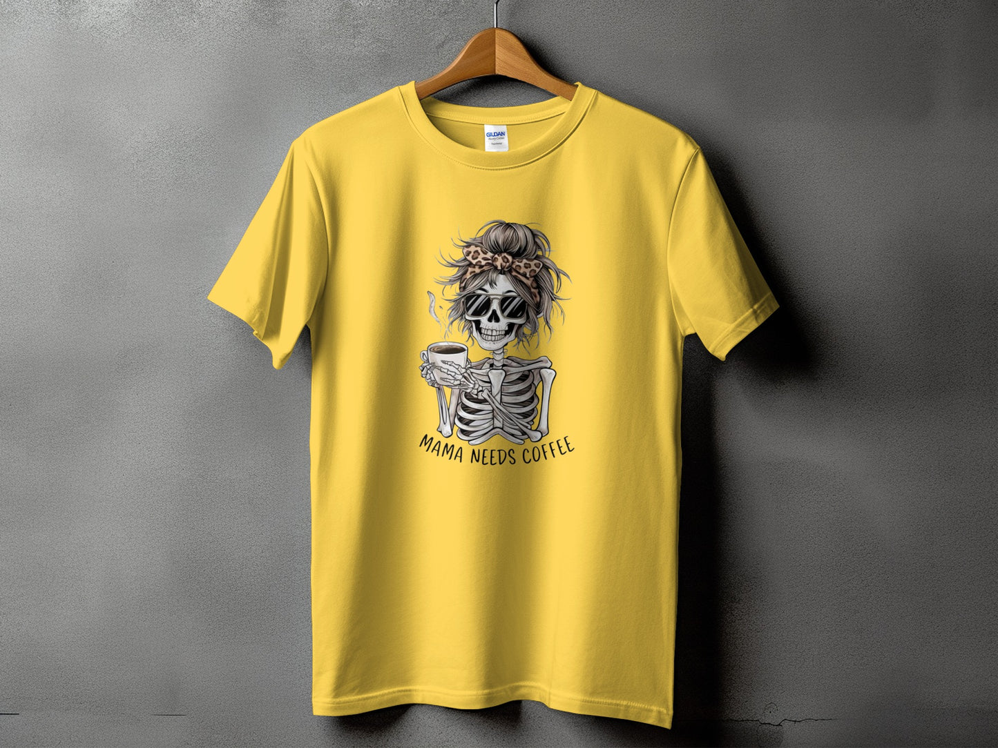 Yellow t-shirt with skeleton graphic and text "MAMA NEEDS COFFEE".