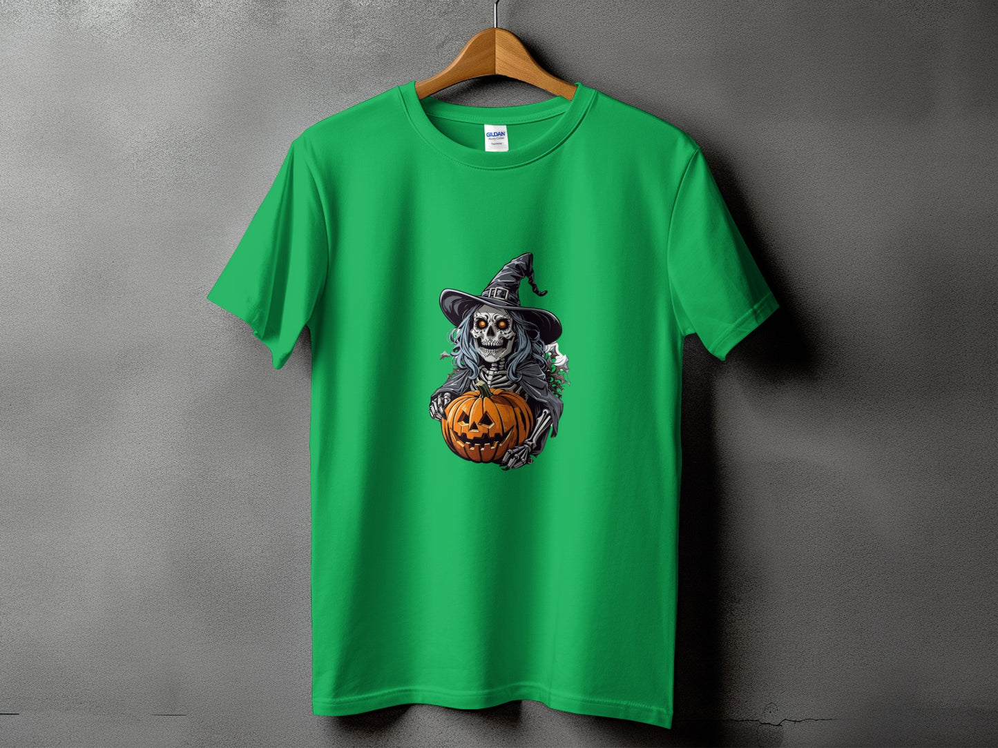 Green t-shirt with a skeleton in a witch hat holding a jack-o'-lantern.