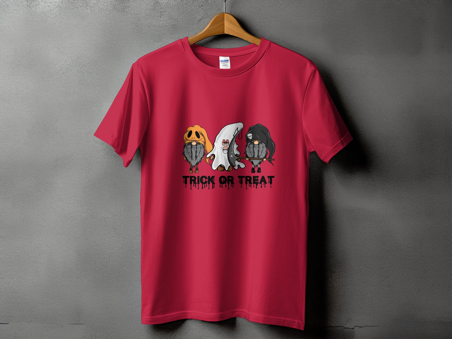 Red t-shirt with three gnomes in Halloween costumes and the text "TRICK OR TREAT".