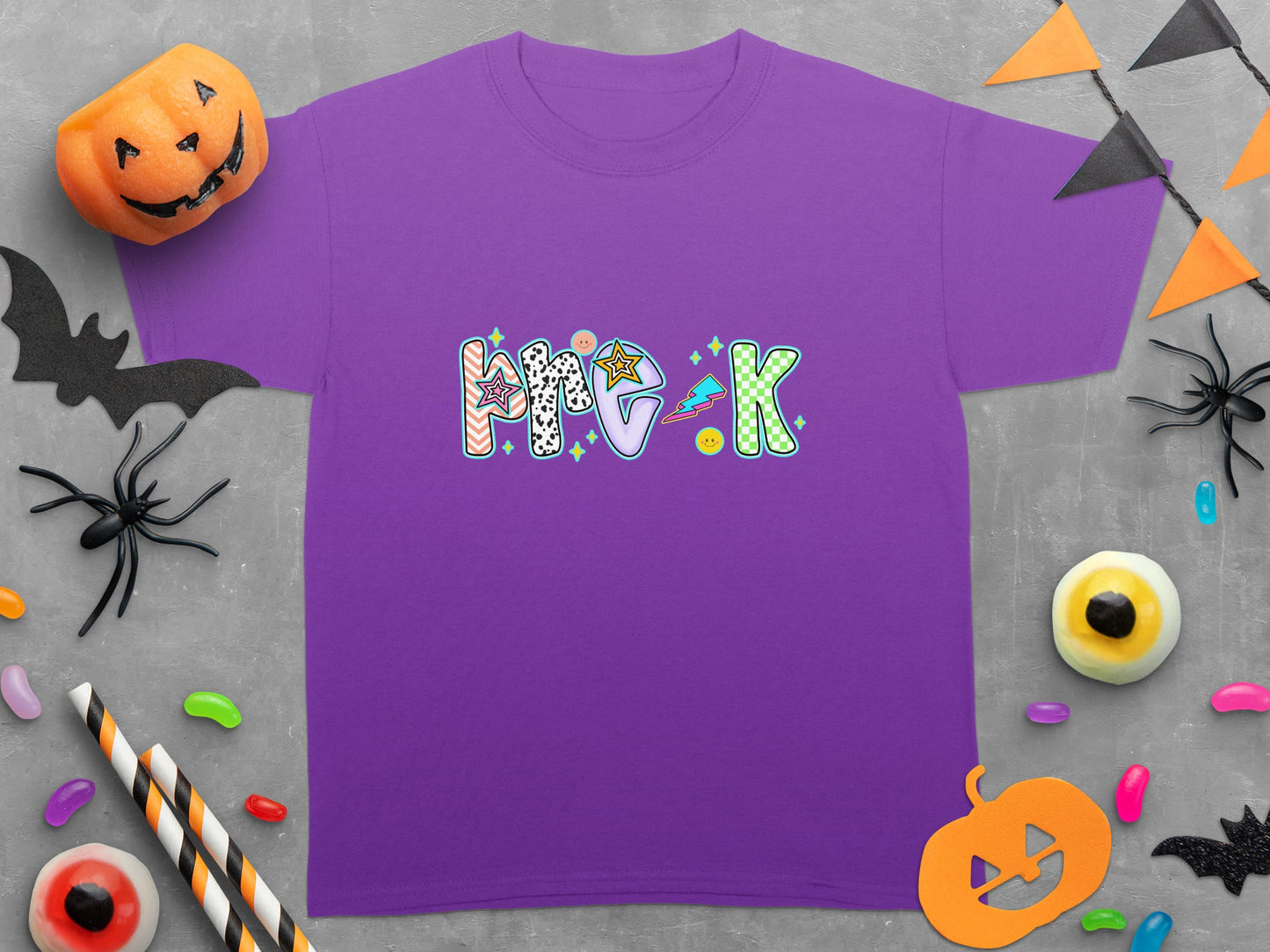 Purple t-shirt with a colorful "Pre-K" graphic and Halloween decorations.
