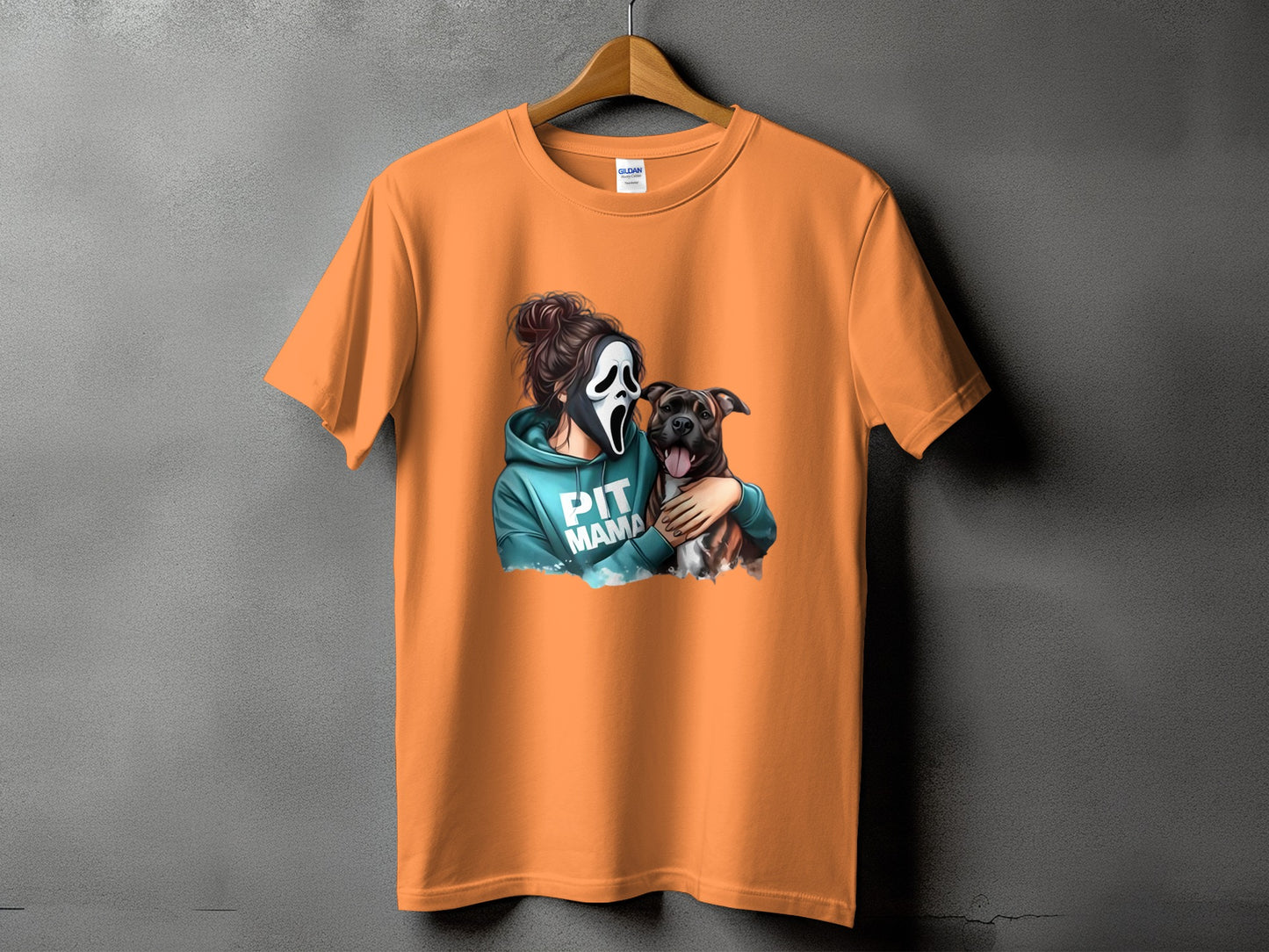 Orange t-shirt featuring a woman in a ghost mask holding a pit bull and text "PIT MAMA".