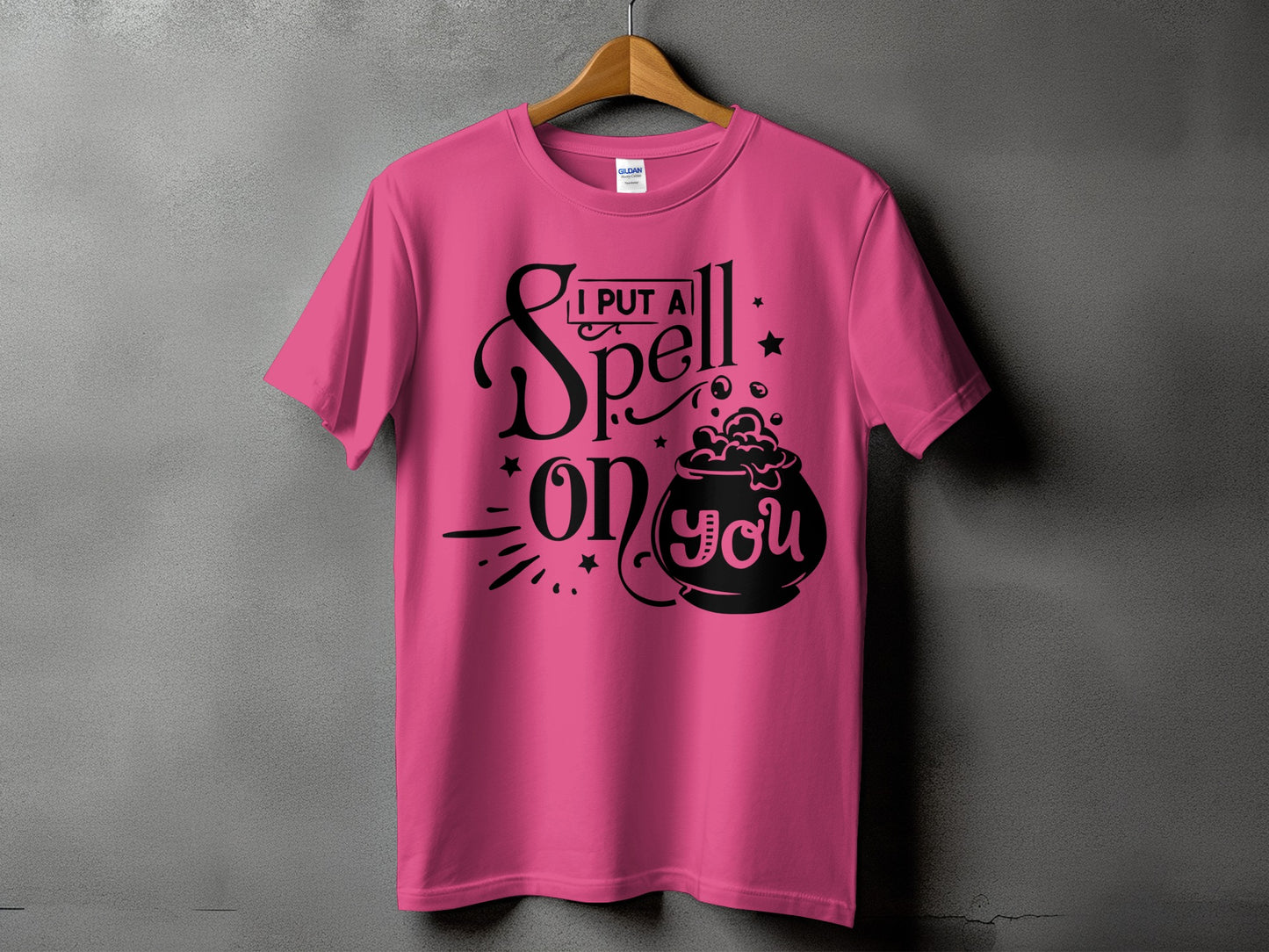 Pink t-shirt with "I PUT A Spell on you" Halloween graphic.