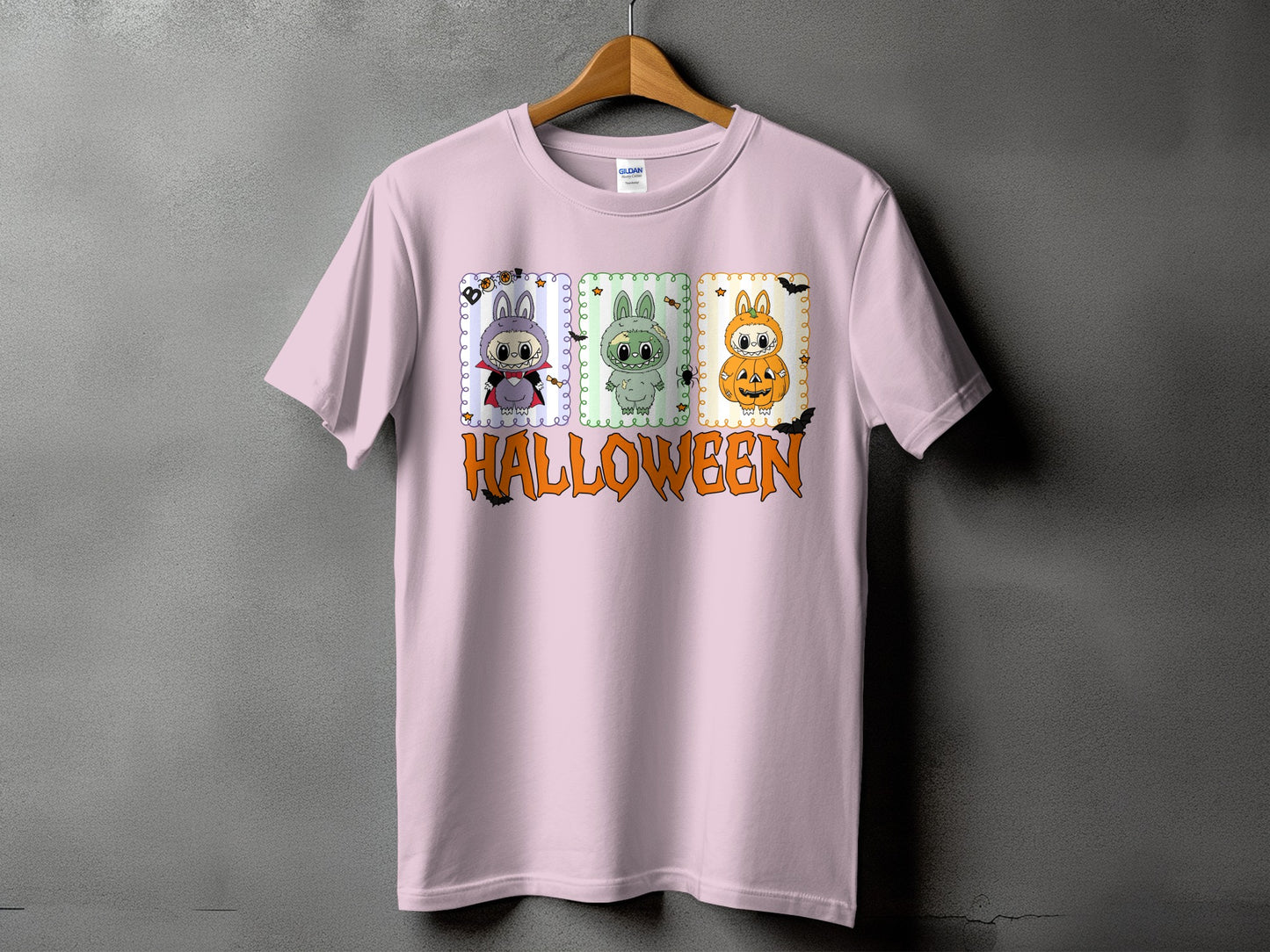 Pink t-shirt with three Halloween-themed cartoon characters and the word "HALLOWEEN."