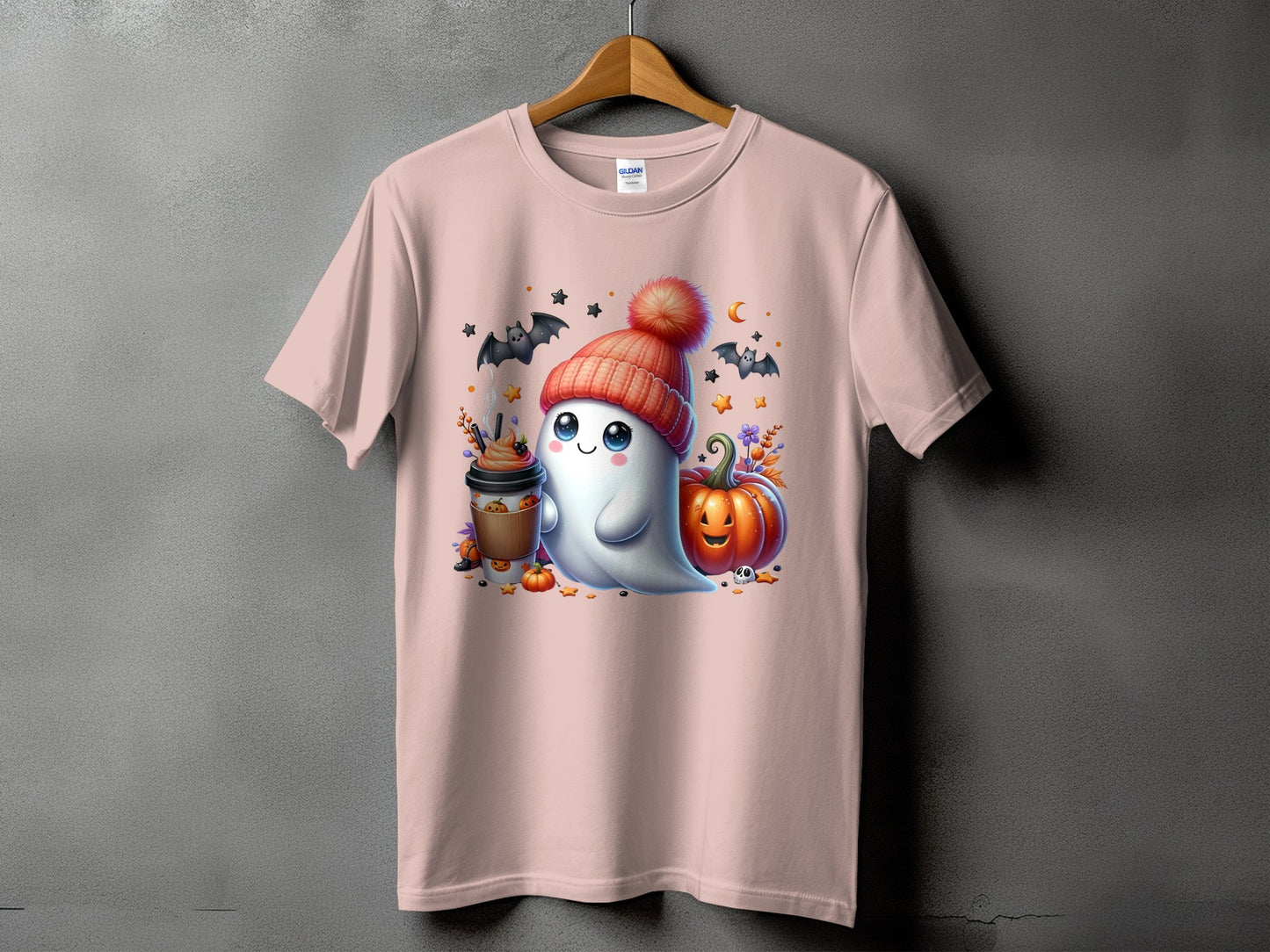 Pink t-shirt featuring a kawaii ghost with a pumpkin, coffee, and bats.