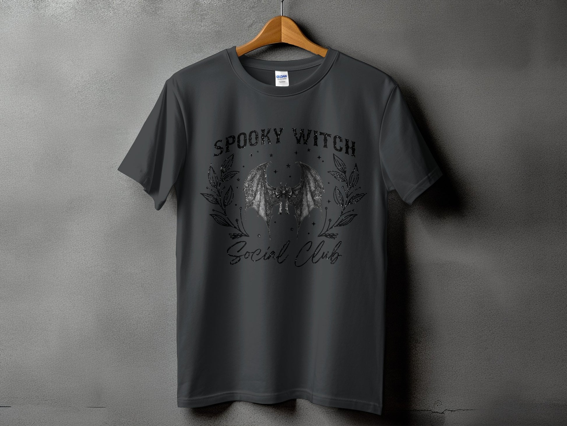 Dark grey t-shirt with "Spooky Witch Social Club" text and bat graphic.