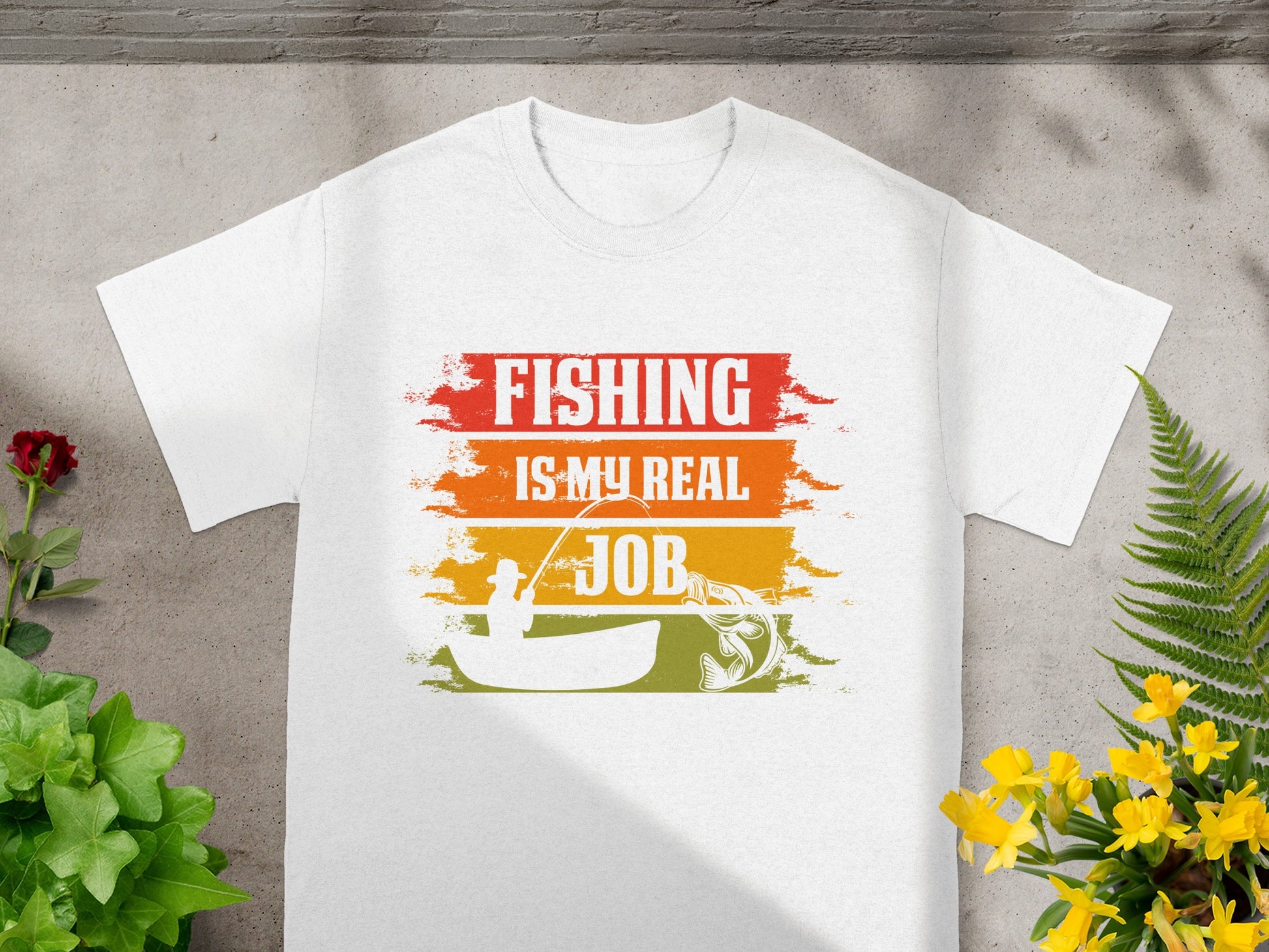 White t-shirt with "FISHING IS MY REAL JOB" text and fishing graphic.